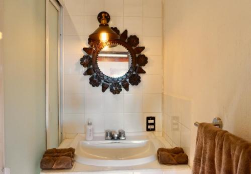 a bathroom with a sink and a mirror at Mini Lofts Ajijic in Ajijic