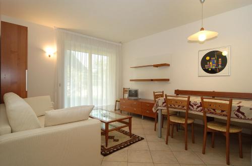 a living room with a couch and a table at Hotel Karinhall in Trento