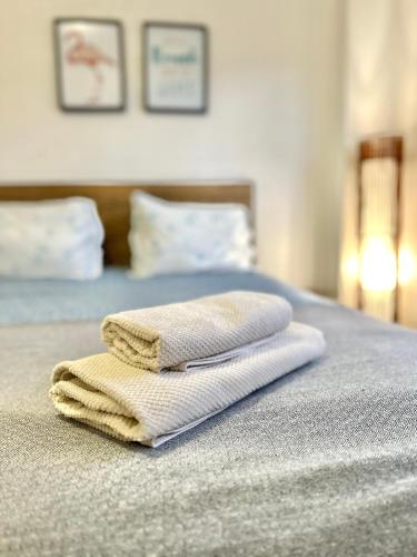 two towels sitting on top of a bed at Apartamento Fonte Velha in Nazaré