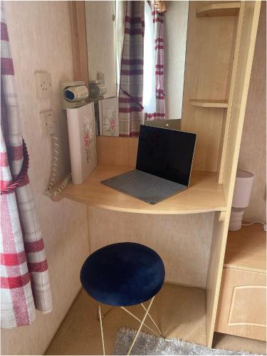 a toy desk with a laptop and a blue stool at The Wee Sprout in Stranraer