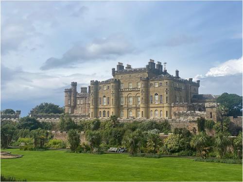 a large castle sitting on top of a lush green field at The Wee Sprout in Stranraer