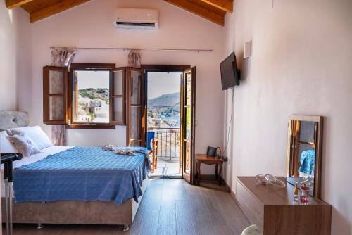 a bedroom with a bed and a window with a view at Oceanis apartment in Symi