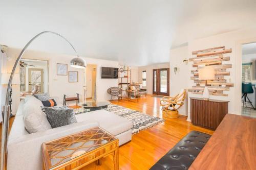 a living room with a white couch and a table at Private Riverside Retreat in Appleton