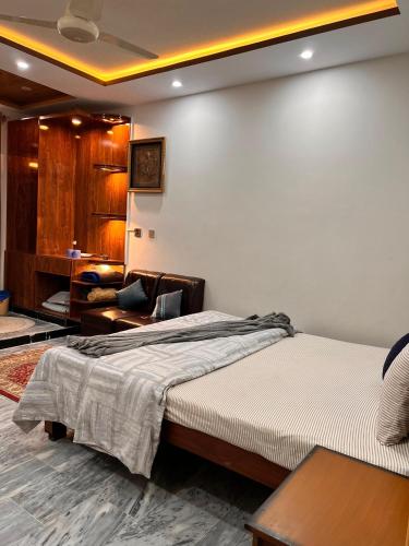 a bedroom with a bed and a living room at Sarai Abbottabad in Abbottabad