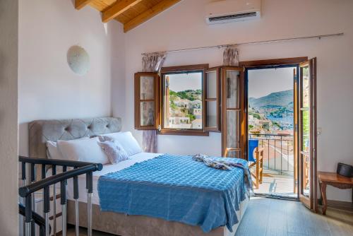 a bedroom with a bed and a balcony at Oceanis apartment in Symi