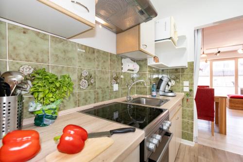 a kitchen with tomatoes on a counter and a sink at Ferienwohnung Nolte Grömitz in Grömitz