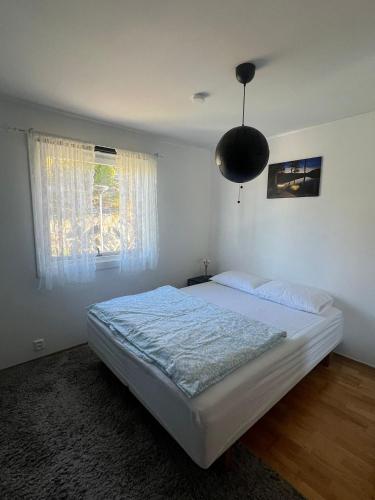 a bedroom with a white bed and a window at Cozy room in Lutvann 2 in Oslo