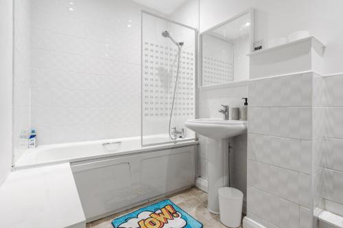a white bathroom with a sink and a shower at City Stay Haven - Coop Live - Etihad - Sleeps 9 - Free Parking in Manchester