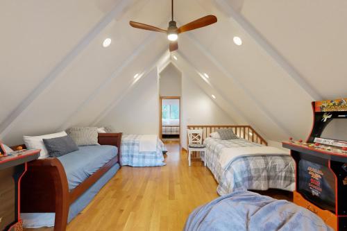 a attic room with two beds and a ceiling fan at Tahoe West Shore Escape in Tahoe City