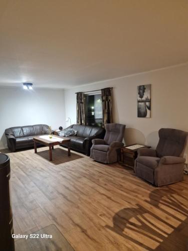 a living room with two couches and a table at Leiligheten i Rørvik 