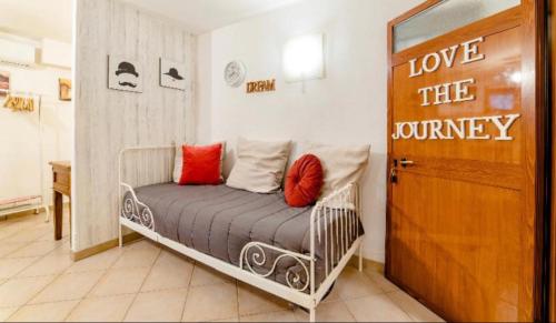 a bedroom with a bed with a sign that reads love the journey at Tabor 1 garden & parking in Naples