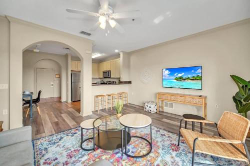 a living room with a table and chairs at 2BR Condo with pool, near Disney! in Orlando