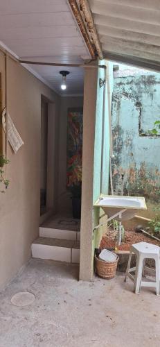 a room with a sink and a painting on the wall at Hospedagem da Fran in Brasília
