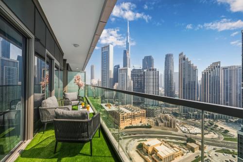 a balcony with chairs and a view of the city at Highest infinity Pool in Downtown Dubai in Dubai