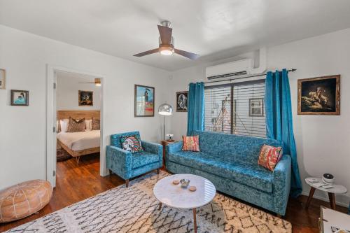 a living room with a blue couch and a table at Saint Boniface Hotel in Indio