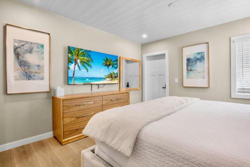 a bedroom with a bed and a dresser with a tv at Haley's at Anna Maria Island Inn in Holmes Beach