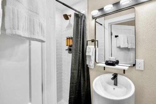 a white bathroom with a sink and a mirror at Haley's at Anna Maria Island Inn in Holmes Beach