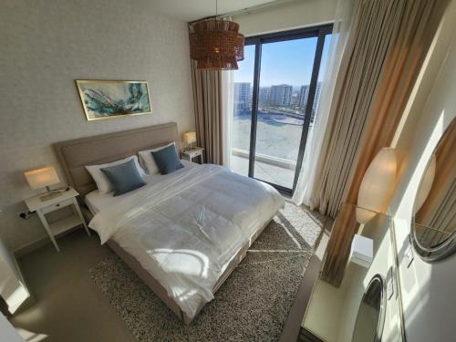 a bedroom with a bed and a large window at Elite 2BR Abode Distinctive Living at The Shores in Manama