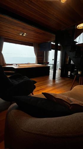 a living room with a couch and a pool table at The Valley Cabin in Barracão