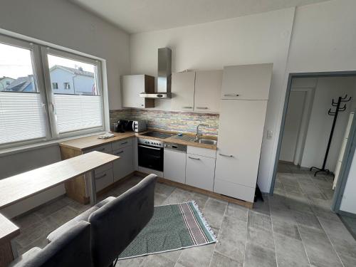 a kitchen with white cabinets and a counter top at Wohnung 6 Toni in Oedt