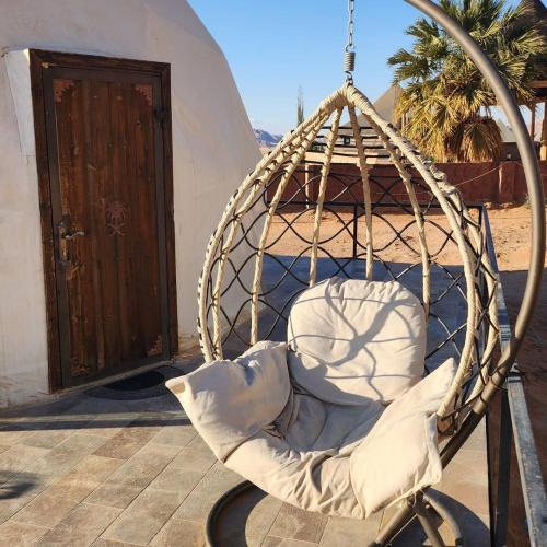 a swing in front of a building with a door at hamza in Wadi Rum