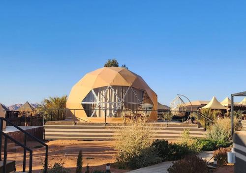 a building with a domed roof with stairs in a desert at hamza in Wadi Rum
