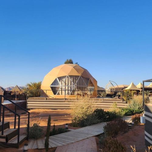 a domed building with steps and a building with a dome at hamza in Wadi Rum