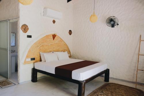 a bedroom with a bed in a room at Birds of Paradise Surf and Yoga Boutique & Retreat in Weligama