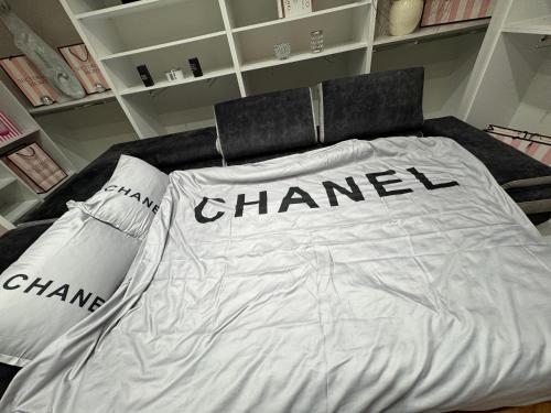 a white bed with the words chanel on it at Analadyboss in Leskovac