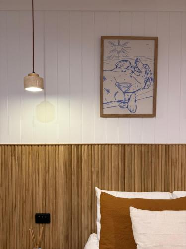 a bedroom with a picture on the wall above a bed at Waters Edge - Dunbar Court - Central Location in South West Rocks