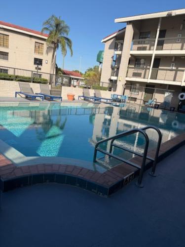 a swimming pool in front of a apartment building at La Quinta by Wyndham St Petersburg-Clearwater in Pinellas Park