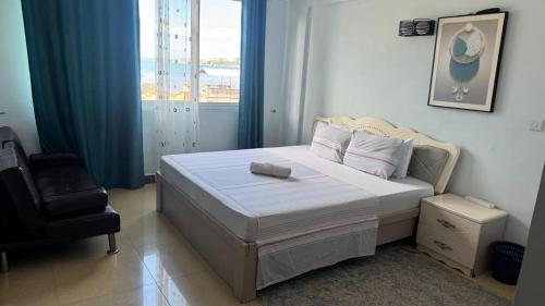 Ένα ή περισσότερα κρεβάτια σε δωμάτιο στο Masaki H and Apartment