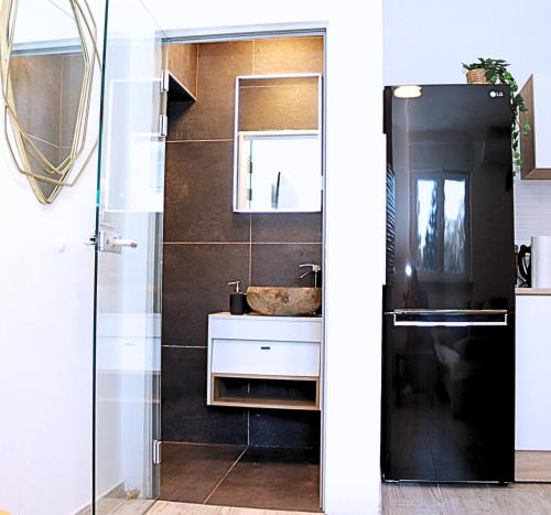 a bathroom with a sink and a mirror at Funktastic Central Maksimir Condo in Zagreb