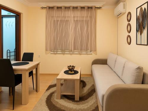 a living room with a couch and a table at Kuća Amazonija in Apatin