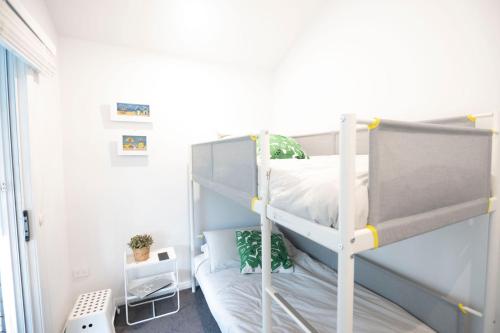 a small bedroom with a bunk bed in a room at Tranquil 3-Bed Home Pet-friendly Retreat with Community Pool in St Georges Basin