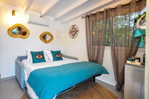 a bedroom with a bed with blue sheets and a window at Villa Princess sea view private pool Anse Marcel in Saint Martin
