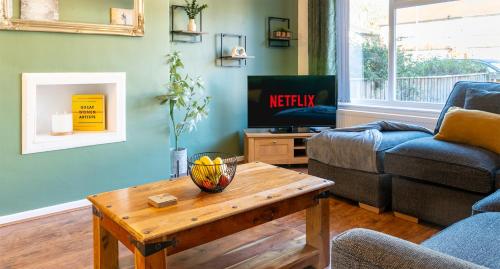 a living room with a couch and a table at Headingley Lodge - Suburban location with off street parking in Leeds