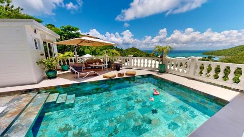 a swimming pool on top of a house at Villa Princess sea view private pool Anse Marcel in Saint Martin