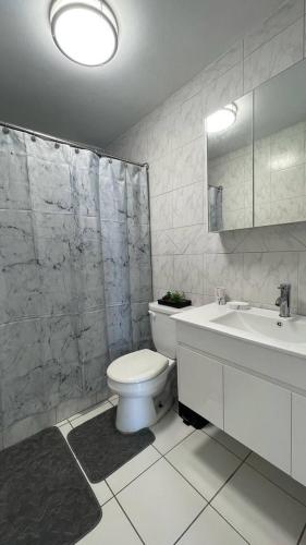 a bathroom with a toilet and a shower and a sink at Ocean Front 2 in San Juan