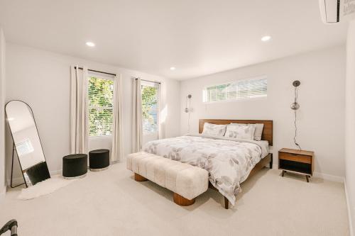 a white bedroom with a bed and a window at Bright & Cozy 4BR Retreat Near Downtown Gresham in Gresham