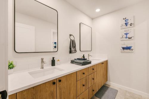 a bathroom with a sink and two mirrors at Bright & Cozy 4BR Retreat Near Downtown Gresham in Gresham