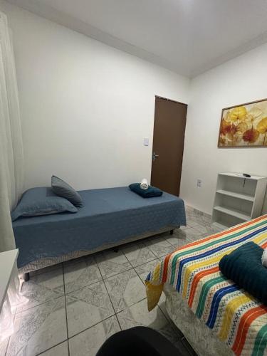 a bedroom with two beds in a room at Cantinho aconchegante - Quarto 09 - AR-condicionado in Bayeux