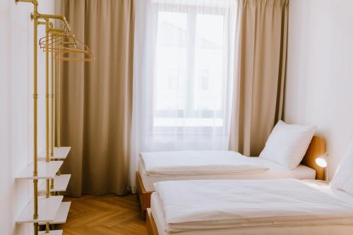 a hotel room with two beds and a window at JUGA Apartmány in Jaroslavice