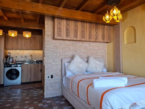 a bedroom with a bed and a kitchen at rooftop studio essaouira in Essaouira