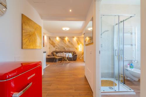 a bathroom with a red cabinet and a glass shower at Dream house in Olbia