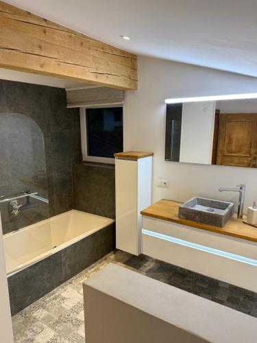 a bathroom with a sink and a tub and a sink at Chalet Pallegg in Hinterthal