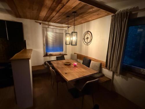 a dining room with a wooden table and chairs at Chalet Pallegg in Hinterthal