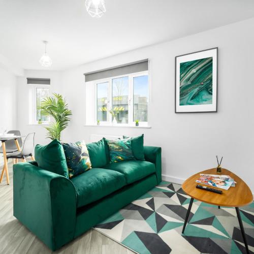 a living room with a green couch and a table at Modern 2 Bed Apartment - Sleeps 3 - Netflix - Parking 55C in Sleightholme