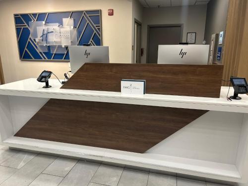 a counter in a store with two phones on it at Holiday Inn Express Fredericksburg - Southpoint by IHG in Fredericksburg