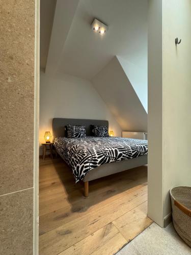 a bedroom with a zebra print bed in a attic at Spacious and Design Loft in Brussels